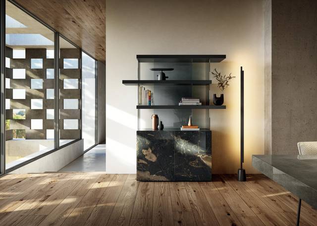 Modern living room with a sleek black marble bookshelf, open wooden shelves, decorative items, and floor-to-ceiling windows.