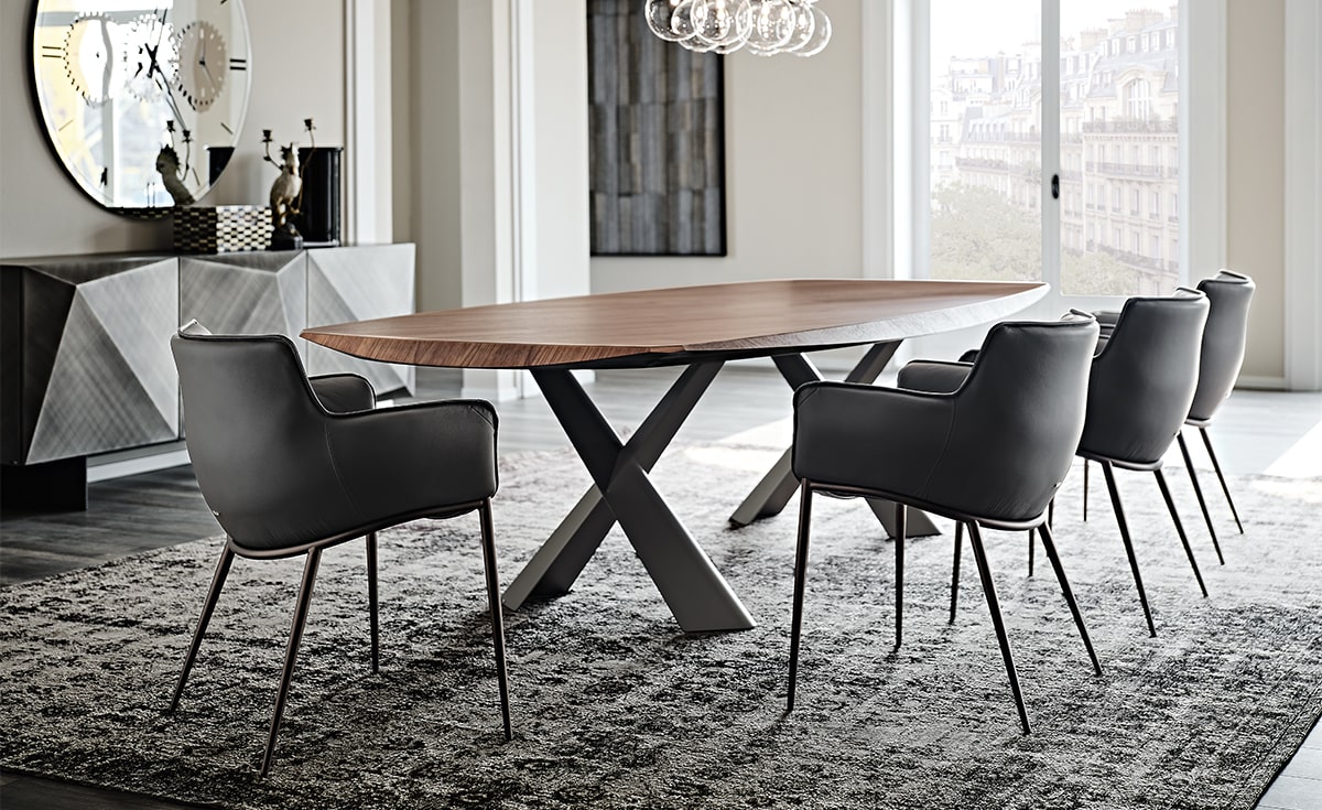 Elegant dining space with padded armchairs and a wooden table showcasing how to choose a dining room chair for style and comfort.