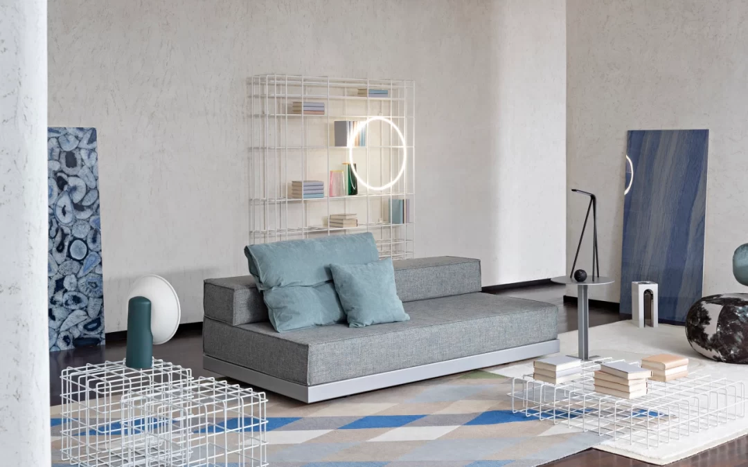 Bed-Breakfast-Feature-1080×675 Contemporary sofa bed with a low profile and plush cushions, ideal for small spaces, styled with layered geometric rugs and avant-garde luxury accessories.
