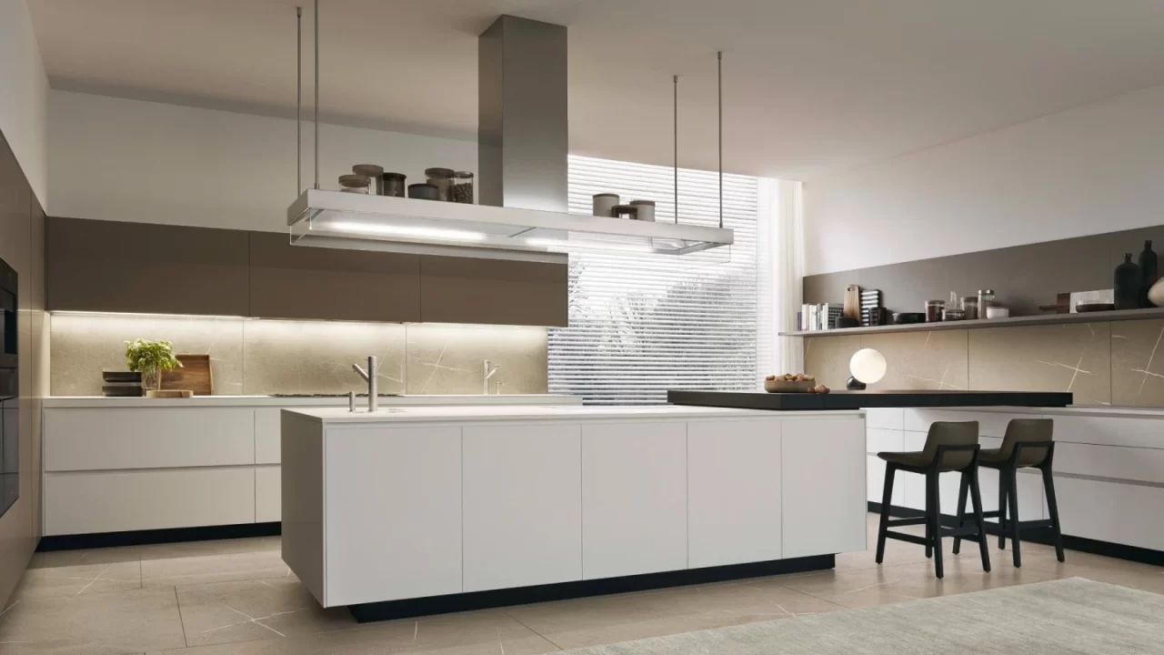 Modern island kitchen layout with sleek modular cabinets, integrated lighting, and a spacious central work area.