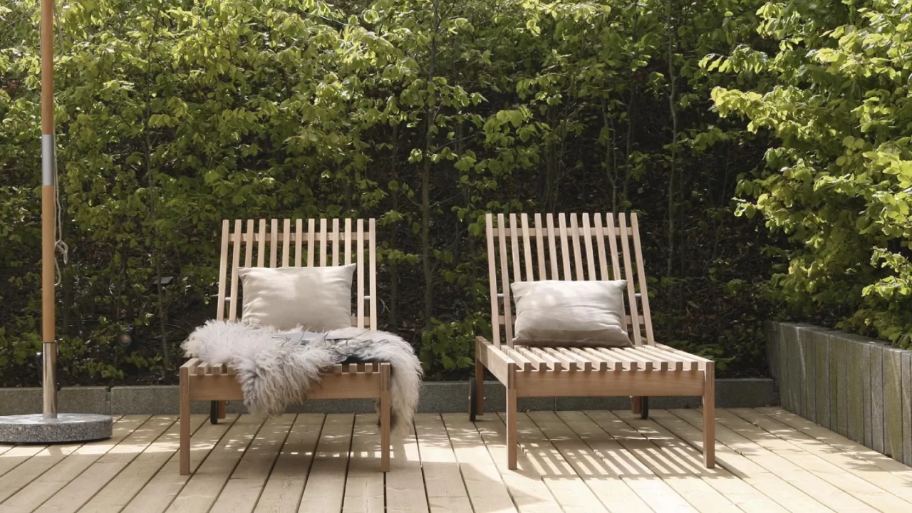 Luxury patio seating with wooden lounge chairs in a private garden.