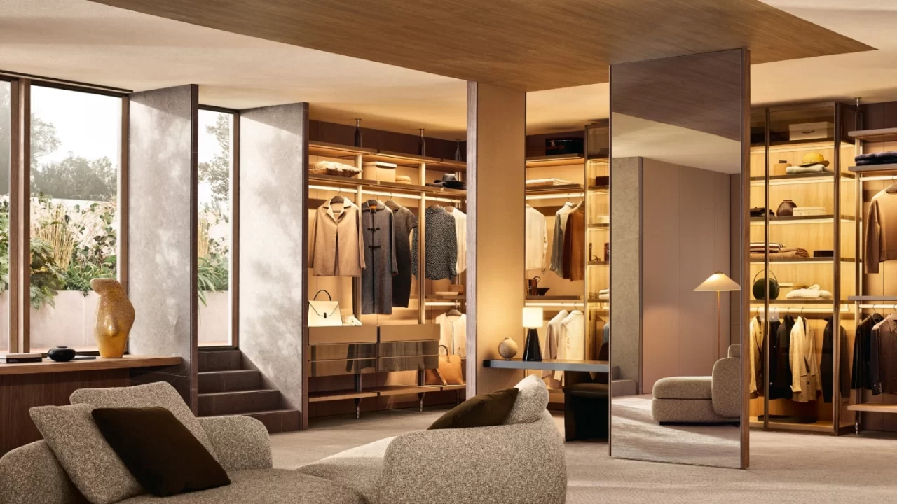 Built in wardrobe lighting ideas for luxury homes. Modern closet featuring vertical LED strip lights and warm ambient illumination for organized clothing storage by Ventura Interiors.